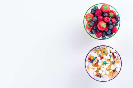 Healthy lifestyle, diet concept, Fruit and pills, vitamin supplements with copy space on white...