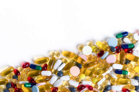 Many different colorful medication and pills from above on white background with copy space