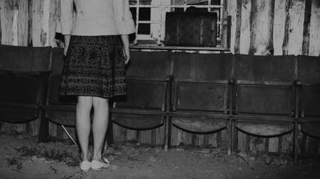 unrecognizable girl and retro vintage suitcase, travel concept, change and move concept, dark mood...
