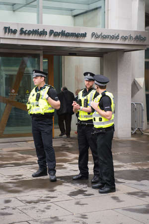 EDINBURGH, SCOTLAND, UK, September 18, 2014- police men guarding scottish parlament building on...