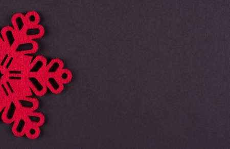 Unusual design christmas background with red snowflakes and copy space on dark grey backgroundの写真素材