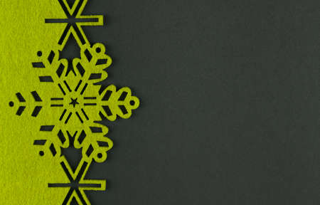 Unusual design christmas background with yellow snowflakes and copy space on dark grey backgroundの写真素材
