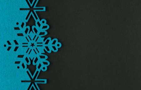 Unusual design christmas background with blue snowflakes and copy space on dark grey backgroundの写真素材