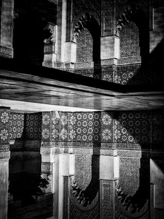Marrakech, MOROCCO - February 10, 2012 - Courtyard carvings water reflexions in Ben Youssef Madrasa, Islamic college in Marrakesh founded in 14th century.のeditorial素材