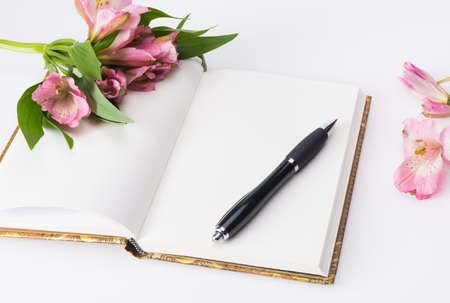 Valentines day, Mothers day composition. Love diary and fresh spring flowers. White background and copy spaceの写真素材