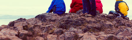 Family enjoying view of Edinburgh from top of Arthurs seat, ancient volcano, Scotland, UK