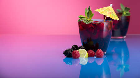 Raspberry and blackberry cocktail with mint garnish. Studio shotの写真素材