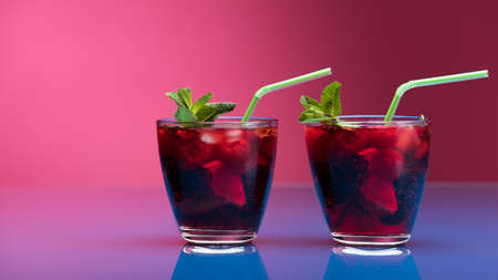 Raspberry and blackberry cocktail with mint garnish. Studio shotの写真素材