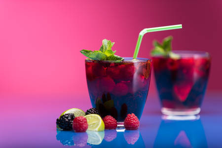 Raspberry and blackberry cocktail with mint garnish. Studio shotの写真素材