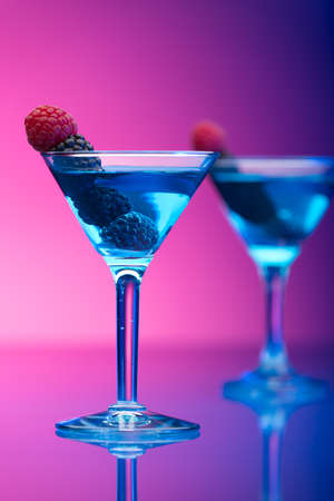 Colorful cocktails garnished with berriesの写真素材