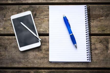 Rustic wooden table with smartphone. View from above with copy spaceの写真素材