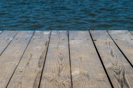 Wooden deck by water, background with copy spaceの写真素材
