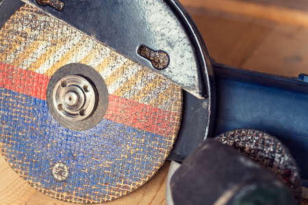 Old used big powerful angle grinder with abrasive disk