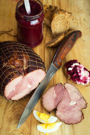 Holiday ham with fresh crusty bread , eggs and condimentsの写真素材