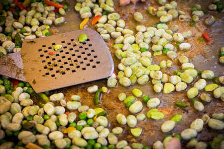 Traditional spanish chicken paella preparation on big pan, outdoors food marketの写真素材