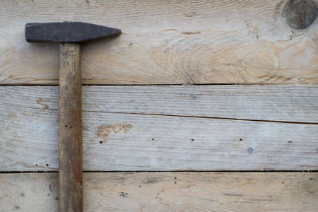 Wooden background with a hammer, home improvement concept