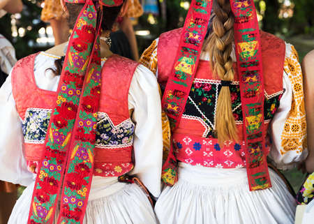 Anonymous girls in folklore costumes, back detailの写真素材