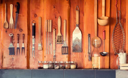 Grill, bbq area with tools hanging on the wallの写真素材