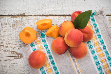 Fresh homegrown apricots on vintage white wooden tableの写真素材