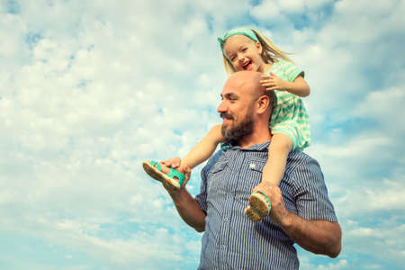 Adorable daughter and father portrait, happy family, future conceptの写真素材