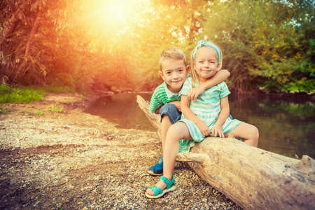 Adorable siblings posing for a portrait, summer outdoors conceptの写真素材