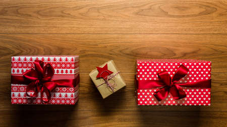 Beautifuly wrapped vintage christmas presents on wooden background, view from above, with copy space