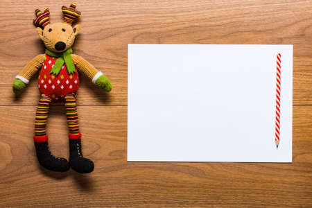Empty letter to santa od a desk with cute reindeer toyの写真素材