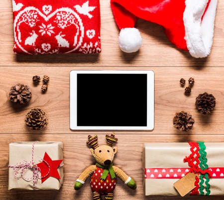 Desk view from above with digital tablet and presents, online shopping retro xmas concept with copy spaceの写真素材