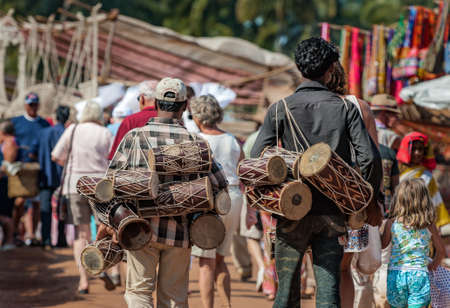 Goa, India - January 2008 - Tourists and local traders at the famous weekly flea market in Anjuna, Goaのeditorial素材