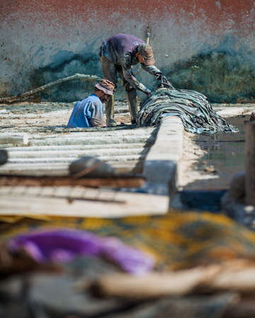 MARRAKESH, MOROCCO - February 2012 - Workers in the tannery souk of weavers, old medina part of Marrakeshのeditorial素材