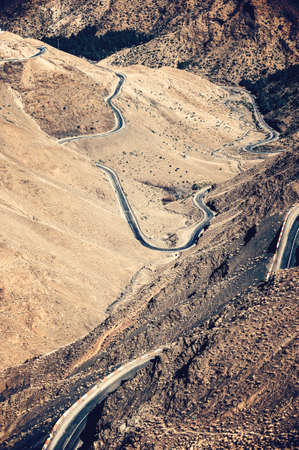 Road leading through dry and cold rough landscape of high Atlas mountains, Moroccoの写真素材