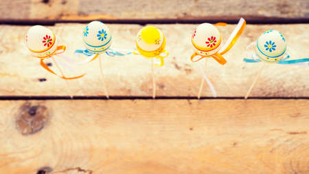 Colorful Easter eggs on wooden background