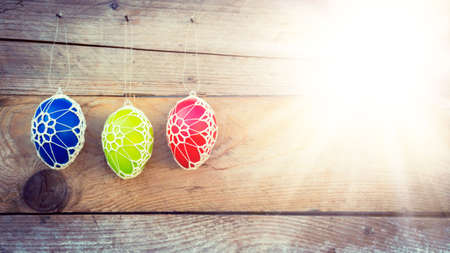 Colorful Easter eggs on wooden background