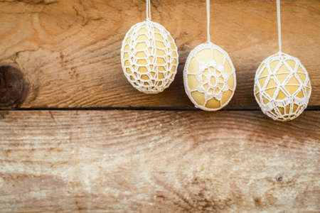 Crochet pattern Easter eggs on wooden backgroundの写真素材