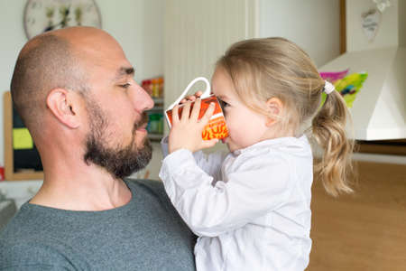 Father and daughter in the kitchen, fathers day concept, real familyの写真素材