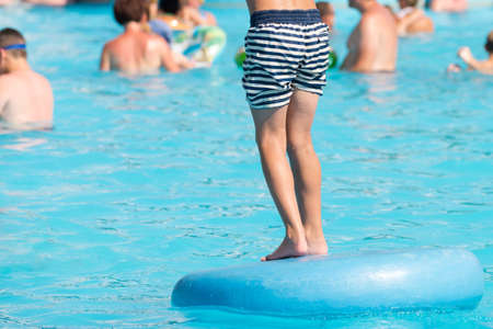 Child in swimming pool. Aqua park summer vacation conceptの写真素材