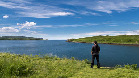 Man admiring the beauty of scottish landscape, Loch Harportの写真素材