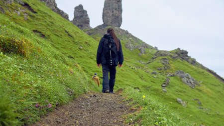 Man walking to the Old man of Storr, Scotlandの写真素材