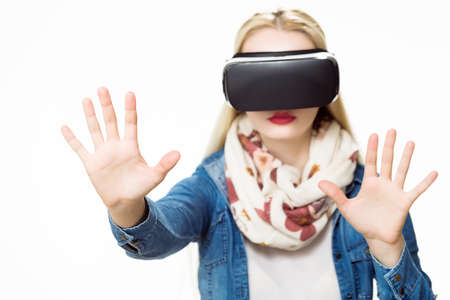 Attractive woman wearing virtual reality glasses. VR headset. Virtual reality concept on white...
