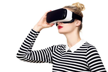 Attractive woman wearing virtual reality glasses. VR headset. Virtual reality concept on white...