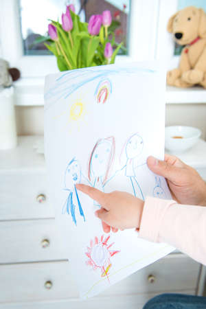 Cute blond girl giving her father a drawing, fathers day conceptの写真素材