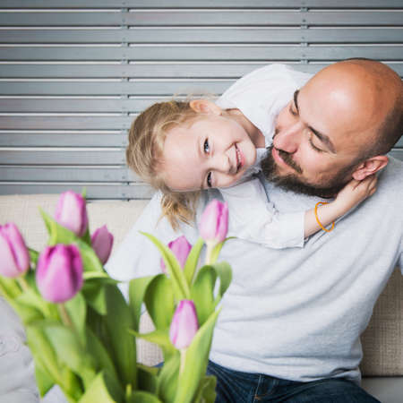 Happy family concept, father and daughter portrait, sitting on a couch having funの写真素材