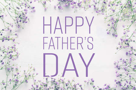 White wooden table with purple flowers, Happy father's day concept