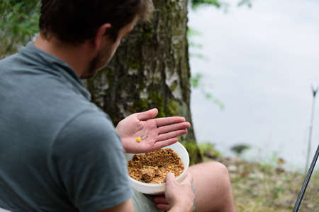 Fisherman preparing lure, fishing getaway vacation hobby conceptの写真素材