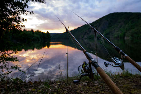 Freshwater fishing with rods on Vltava at sunset, Czech Republicの写真素材