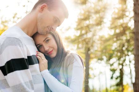 Happy young couple in love hugging. Park outdoors date. Loving couple happiness.の写真素材