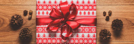 Magical christmas theme background, xmas present and pine cones on wooden table. Christmas web banner flat layの写真素材