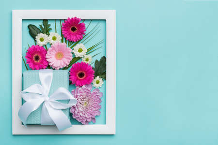 Happy Mother's Day, Women's Day, Valentine's Day or Birthday Pastel Candy Colors Background. Floral flat lay minimal concept with beautifully wrapped present.の写真素材