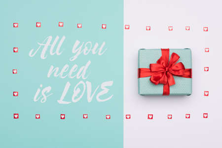 Flat lay of beautifully wrapped present in pastel blue candy colourの写真素材