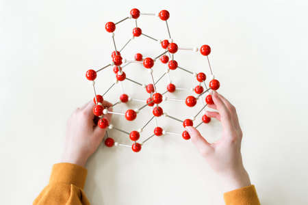 Student holding molecular structure model. Science class concept. Personal perspective view.の写真素材
